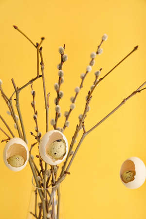 Creative composition with pussy willow branches and Easter eggs near color wallの写真素材