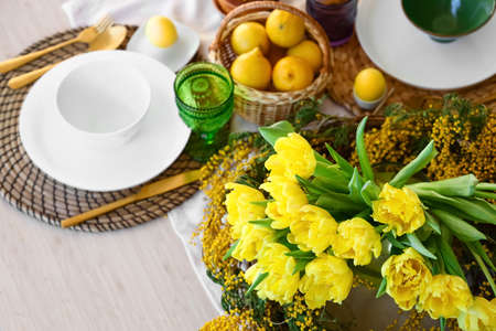 Beautiful flowers on dining table served for Easter celebrationの写真素材