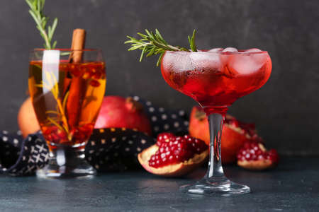 Glasses of tasty pomegranate cocktail on black backgroundの写真素材