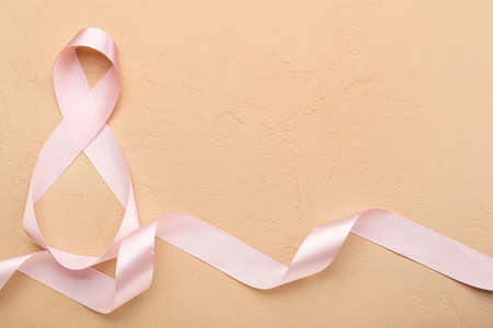 Figure 8 made of ribbon for International Women's Day celebration on beige backgroundの写真素材