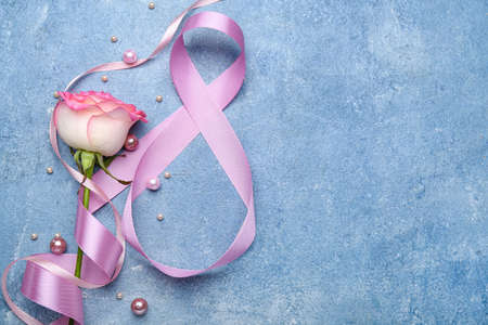 Composition with ribbon and flower for International Women's Day celebration on blue backgroundの写真素材
