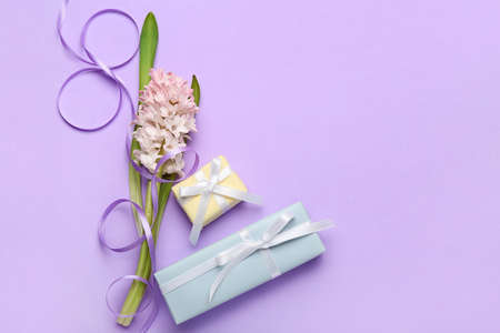 Composition with figure 8 made of ribbon, flowers and gift boxes for International Women's Day...