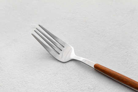 Stylish stainless steel fork on light background, closeupの写真素材