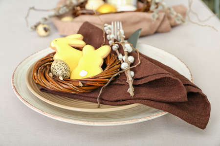 Easter table setting with cookies in shape of bunny and pussy willow branches