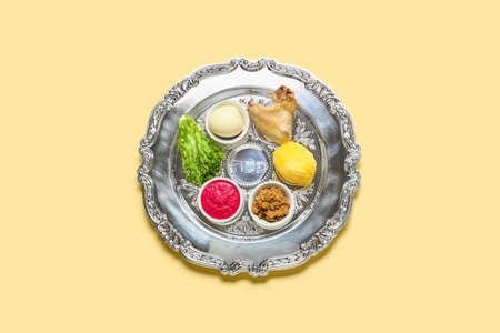 Passover Seder plate with traditional food on light background, top viewの写真素材