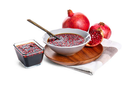 Bowls of pomegranate molasses on white backgroundの写真素材