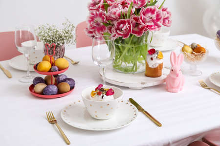 Plate with Easter cake on festive served table