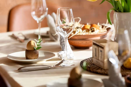 Plate with egg and eucalyptus branch on table served for Easter celebrationの写真素材