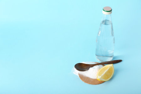 Bottle of water, baking soda and lemon slice on color backgroundの写真素材