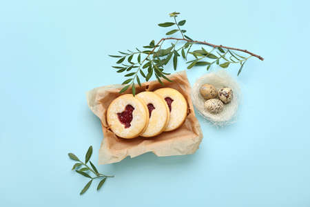 Box with delicious Easter cookies on blue background