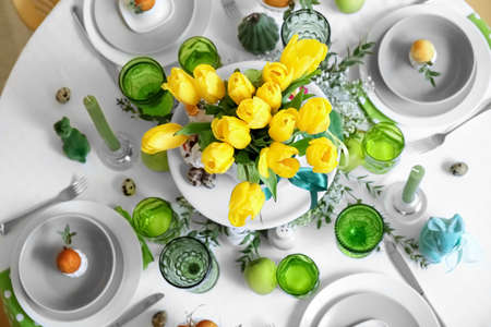 Festive table setting and beautiful tulips for Easter celebrationの写真素材