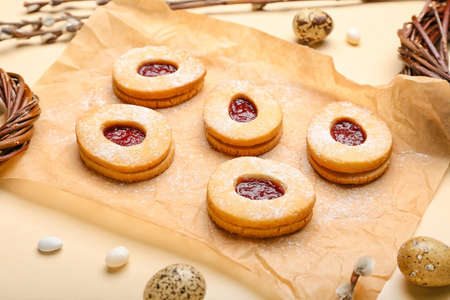 Parchment with delicious cookies for Easter on beige background
