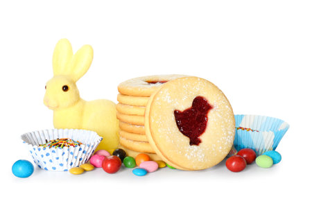 Delicious cookies for Easter and candies on white background