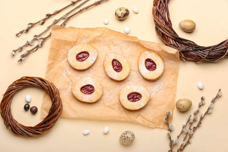 Parchment with delicious cookies for Easter on beige background