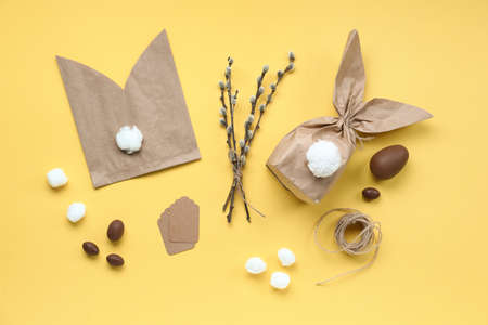 Composition with materials for making Easter bunny gift bags, chocolate eggs and pussy willow...