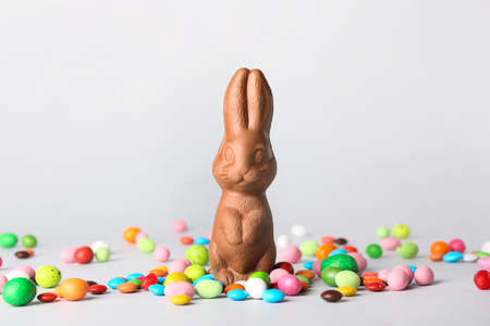 Easter chocolate bunny and candies on white background