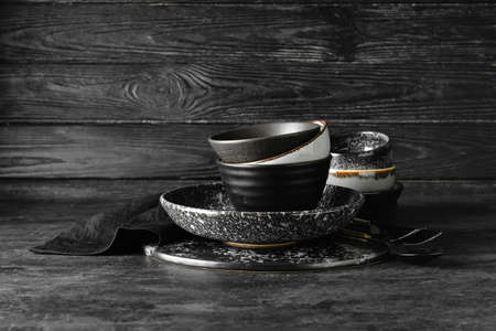 Set of stylish dinnerware on dark wooden backgroundの写真素材