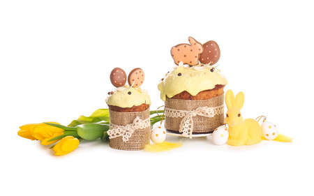Delicious Easter cakes decorated with cookies on white background