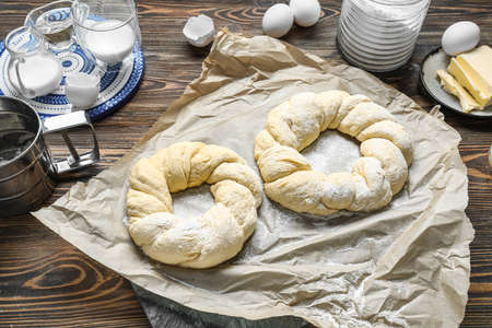 Uncooked Italian Easter bread on wooden background