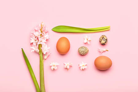 Beautiful Easter composition with eggs and spring flowers on pink backgroundの写真素材