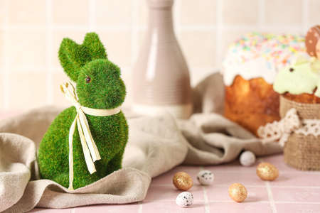 Green Easter bunny and eggs on tableの写真素材