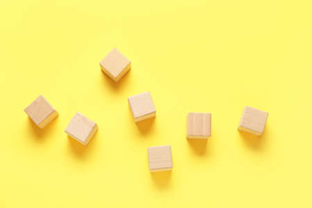 Wooden cubes on yellow backgroundの写真素材