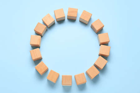 Frame made of wooden cubes on blue backgroundの写真素材