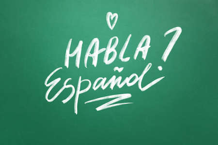 Text HABLA ESPANOL? (DO YOU SPEAK SPANISH?) on school blackboardの写真素材