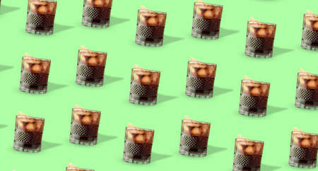 Glasses of tasty Cuba Libre cocktail on green background. pattern for design