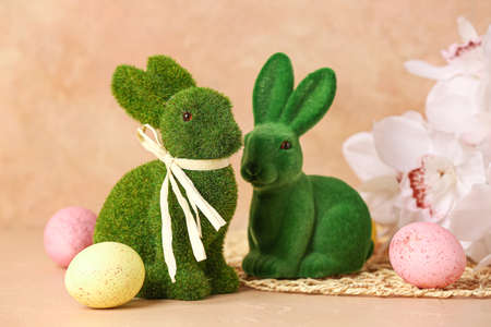 Green Easter bunnies and eggs on color backgroundの写真素材