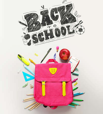 Backpack with stationery and text BACK TO SCHOOL on light background