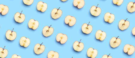Fresh apples on blue background. pattern for designの写真素材