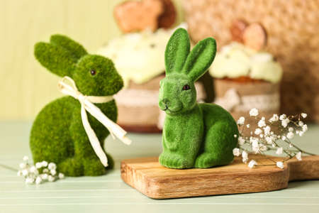 Green Easter bunnies on wooden tableの写真素材