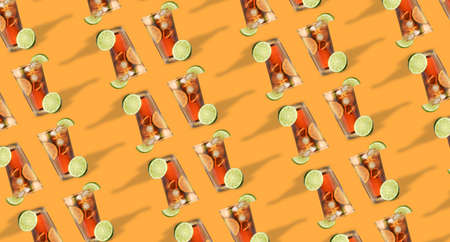 Glasses of tasty Cuba Libre cocktail on orange background. pattern for design