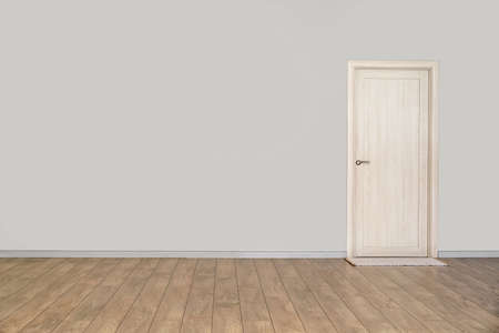 View of light wall with door and mat in big empty roomの写真素材