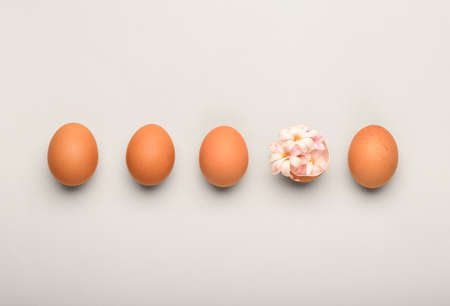 Easter eggs and flowers on yellow backgroundの写真素材