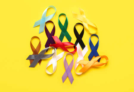 Awareness ribbons on yellow background. World Cancer Dayの写真素材