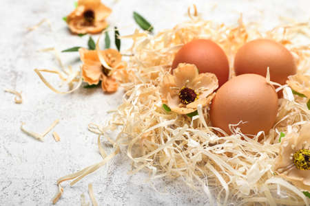 Easter eggs and flowers on light backgroundの写真素材