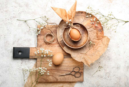 Composition with Easter eggs, flowers, rope and scissors on light backgroundの写真素材