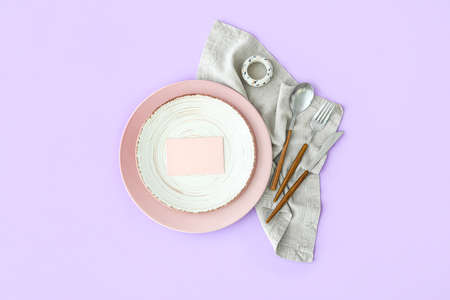 Simple table setting with blank card on purple backgroundの写真素材