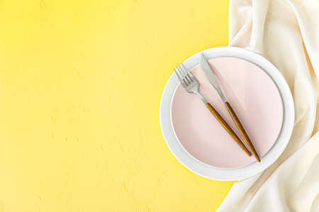 Simple table setting on yellow background