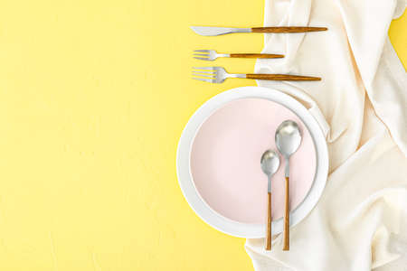 Simple table setting on yellow backgroundの写真素材
