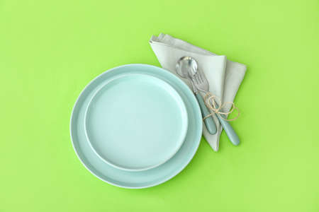 Simple table setting on green backgroundの写真素材