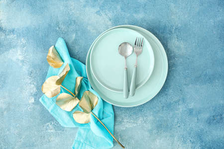 Simple table setting and eucalyptus leaves on blue grunge backgroundの写真素材