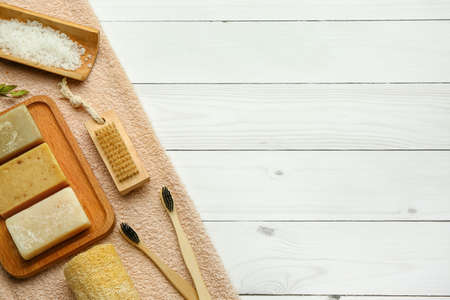 Set of bath supplies with soap bars on light wooden backgroundの写真素材