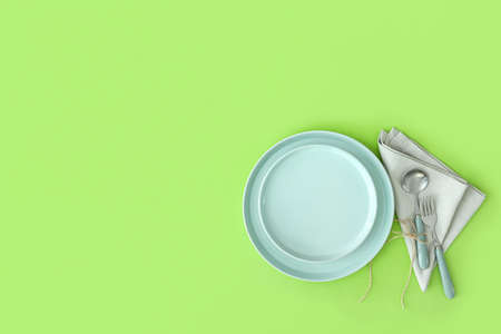 Simple table setting on green backgroundの写真素材