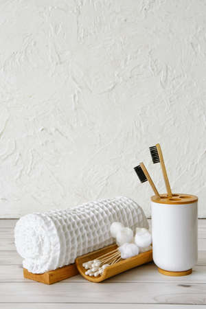 Clean towel, cotton balls, swabs and toothbrushes on tableの写真素材