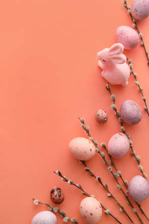 Beautiful Easter eggs, bunny and pussy willow branches on color background