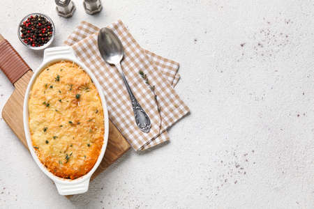Baking dish with tasty Shepherd's pie on light backgroundの写真素材