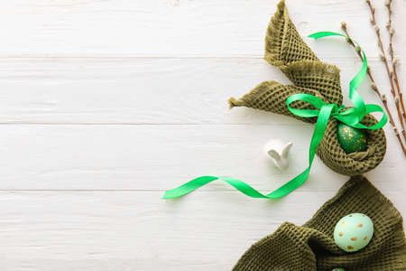 Composition with painted Easter eggs on light wooden backgroundの写真素材